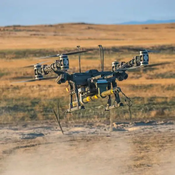 A Lorica Technologies Mule 28 heavy-lift unmanned aerial vehicle delivers a live M1A3 Bangalore torpedo during a U.S. Army proof-of-concept demonstration to breach concertina wire obstacles at Orchard Combat Training Center, Idaho, on June 22, 2026.
