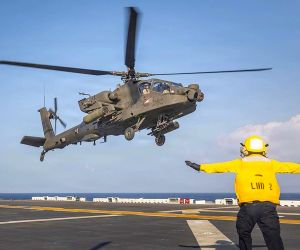 A U.S. Army AH-64 Apache launched from USS Essex during RIMPAC 2026, demonstrating how amphibious ships could serve as mobile strike and sustainment nodes for distributed Pacific operations (Picture Source: U.S. Army)