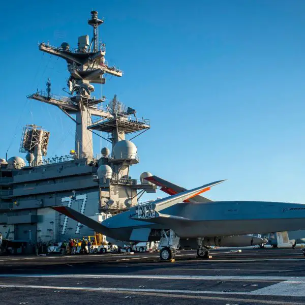 A Boeing unmanned MQ-25 aircraft is given operating directions on the flight deck aboard the aircraft carrier USS George H.W. Bush (Picture source: US DoD)