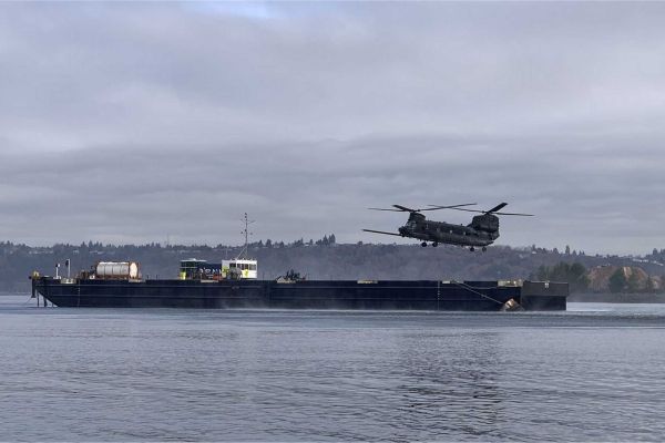 A U.S. Army MH-47G Chinook from the 160th Special Operations Aviation Regiment conducts replenishment operations from an autonomous barge equipped with Sea Machines Robotics’ SM300 system, demonstrating a new maritime logistics concept for long-range U.S. special operations missions.