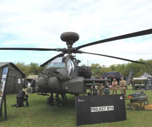 British Army Project NYX is set to expand the operational capabilities of the U.S.-made AH-64E Apache by teaming attack helicopters with armed autonomous drones for reconnaissance targeting electronic warfare and precision strike missions in high-threat environments.