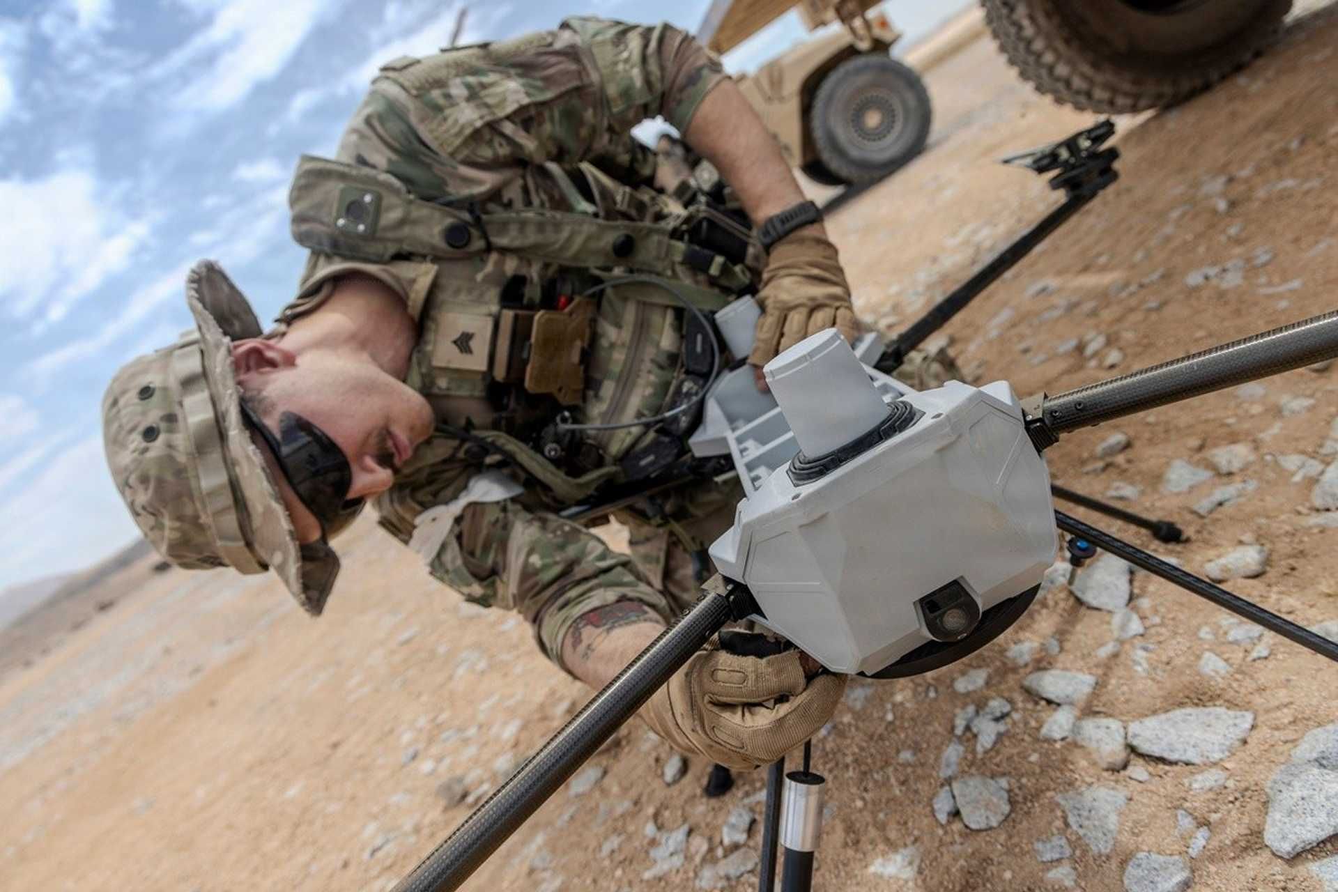 U.S. Army Sgt. Jonathan Simmons, assigned to the 4th Infantry Division, assembles a PDW C-100 drone equipped with the Picatinny Common Lethality Integration Kit during Project Convergence Capstone 6 at Fort Irwin, California, on July 20, 2026. The kit enables compatible drones to carry interchangeable lethal payloads, supporting more flexible strike capabilities for U.S. Army soldiers. (Picture source: U.S. Department of War/Defense)