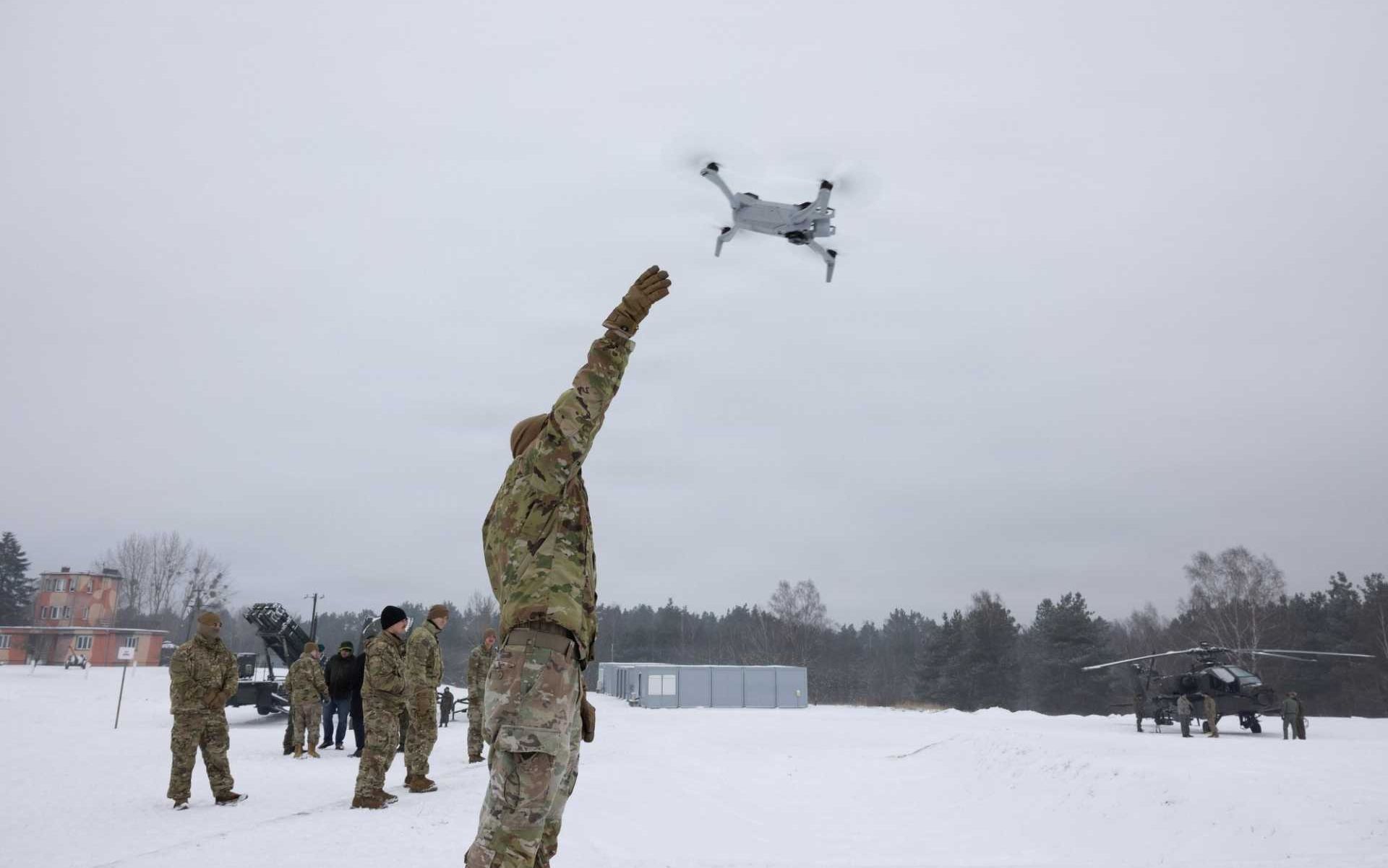 A U.S. Army soldier from the 3rd Squadron, 2nd Cavalry Regiment launches a drone during Operation Winter Falcon 26 at the Drawsko Combat Training Center in Oleszno, Poland, on January 13, 2026. The live drone deployment showcased how unmanned aerial systems are reshaping joint defensive tactics and battlefield awareness for future NATO operations along the alliance's eastern flank.