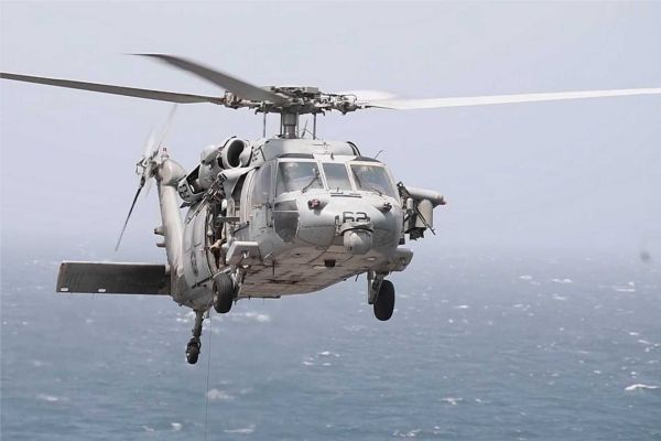 U.S. Navy MH-60R Seahawk armed with AGM-114 Hellfire missiles, illustrating the type of naval helicopter capability used by CENTCOM to intercept and disable the Panama-flagged cargo ship Vela Nova in the Gulf of Oman on August 11, 2026. The MH-60R can carry up to eight Hellfire missiles in a two-launcher configuration and combines maritime surveillance sensors with precision surface-strike capability.