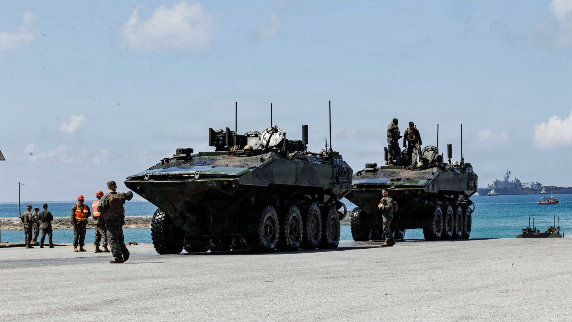 U.S. Marines with the 3rd Assault Amphibian Battalion, 31st Marine Expeditionary Unit, guide Amphibious Combat Vehicles (ACVs) ashore from USS Rushmore (LSD 47) at White Beach Naval Facility, Okinawa, Japan, on July 23, 2026, reinforcing the U.S. Marine Corps' forward-deployed expeditionary presence in the Indo-Pacific.