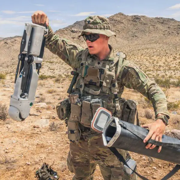 U.S. Army Spc. Tanner Shanklin, assigned to the 4th Infantry Division, prepares a Rogue 1 unmanned aerial system for employment during Project Convergence Capstone 6 at Fort Irwin, California, on July 20, 2026. The man-portable VTOL loitering munition is being evaluated for reconnaissance and precision-strike missions against targets beyond direct line of sight.