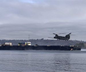 A U.S. Army MH-47G Chinook from the 160th Special Operations Aviation Regiment conducts replenishment operations from an autonomous barge equipped with Sea Machines Robotics’ SM300 system, demonstrating a new maritime logistics concept for long-range U.S. special operations missions.