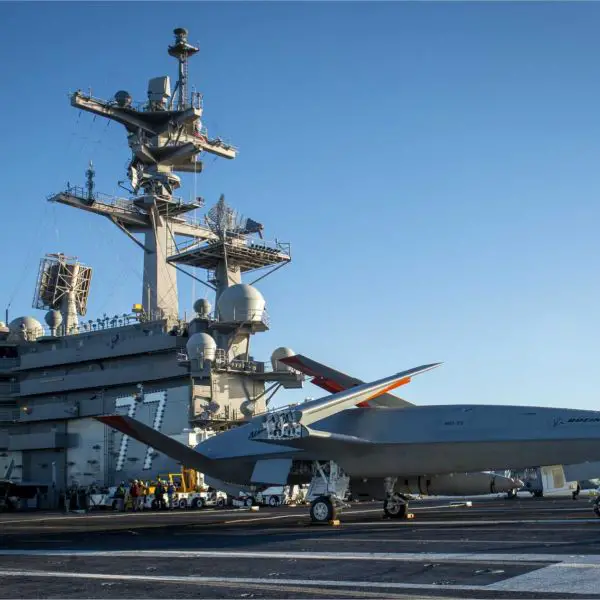 Boeing’s MQ-25 T1 unmanned test aircraft receives deck-handling commands aboard the U.S. Navy aircraft carrier USS George H.W. Bush (CVN-77) during trials supporting the development of the MQ-25A Stingray aerial refueler. (Picture source: U.S. Department of War/Defense)