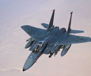 A U.S. Air Force F-15E Strike Eagle conducts a combat air patrol over the U.S. Central Command area of responsibility. The aircraft supports regional deterrence and air-defense missions and has taken on an expanded counter-drone role, including the use of APKWS II guided rockets against unmanned aerial threats.