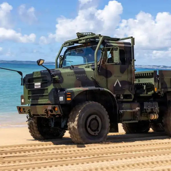 U.S. Marines operate MTVR 6x6 tactical trucks during littoral mobility training at Kin Blue Beach, Okinawa, testing movement across soft sand, unimproved routes and vehicle self-recovery in support of dispersed expeditionary operations (Picture source: U.S. DoW).
