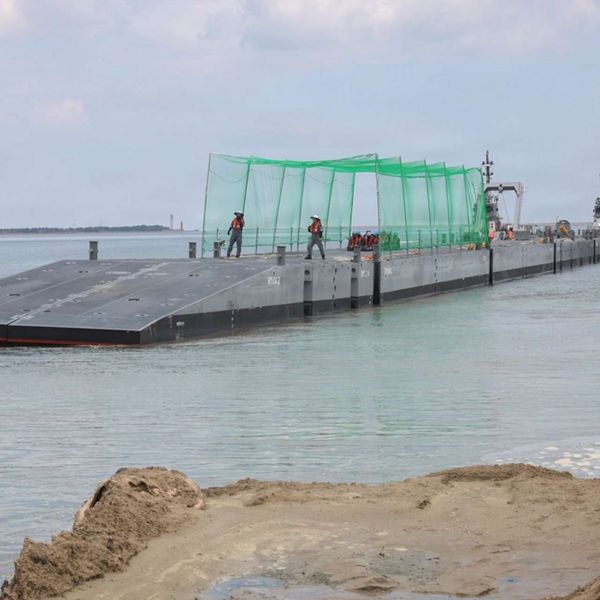 Republic of Korea personnel operate an Improved Navy Lighterage System during CJLOTS 26 at Dogu Beach on July 9, 2026. The causeway ferry carried U.S. Marine Corps vehicles ashore without fixed port infrastructure and featured overhead netting intended to reduce exposure to small drones (Picture source: U.S. DoW).