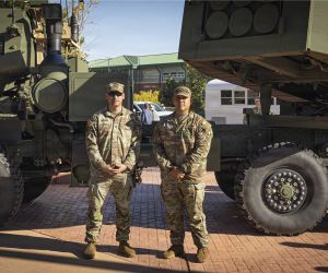 U.S. Army Sgt. 1st Class Matthew Nethers (left) and Sgt. 1st Class Nicolas Adame, assigned to Bravo Company, 1st Battalion, 10th Field Artillery Regiment, 4th Multi-Domain Task Force, stand in front of an M142 HIMARS rocket artillery system during the unit's activation ceremony at Fort Carson, Colorado, on October 8, 2026. (Picture source: U.S. Army)