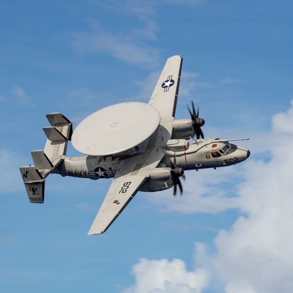 E-2D Advanced Hawkeye assigned to Airborne Command and Control Squadron (VAW) 125 flies over the Nimitz-class aircraft carrier USS George Washington (CVN 73) in the Celebes Sea on November 29, 2025. The aircraft is set to receive the Block II modernization, which will introduce a new digital architecture, increased computing capacity, and an Open Mission Systems framework to support future capability upgrades. (Picture source: US DoD)