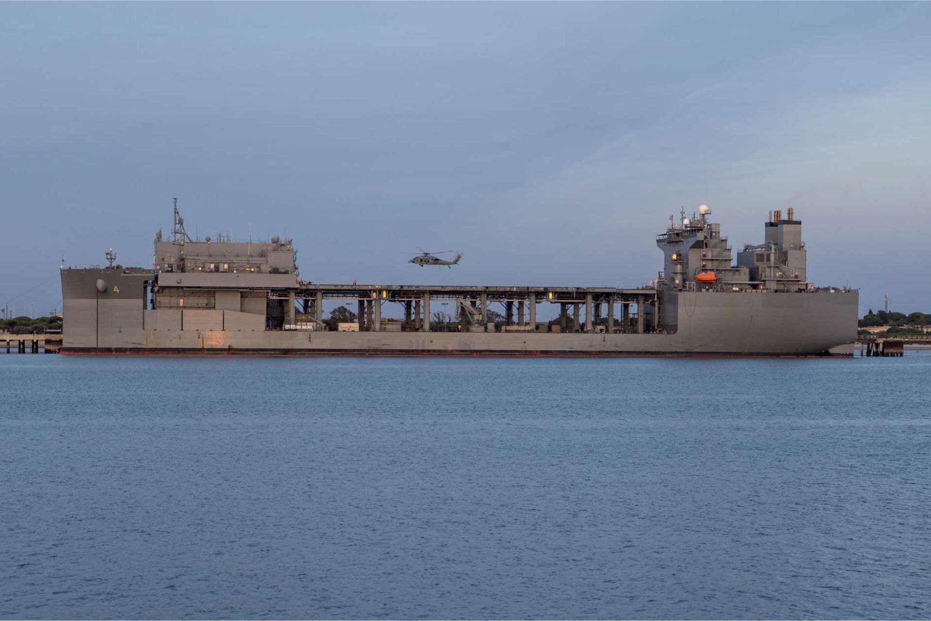 An Expeditionary Sea Base is a 90,000-ton mobile offshore support ship that acts as a floating military hub, providing aviation facilities, mission spaces, personnel accommodation and logistics support for U.S. Navy, Marine Corps, special operations and joint forces without relying on fixed ports or airfields.