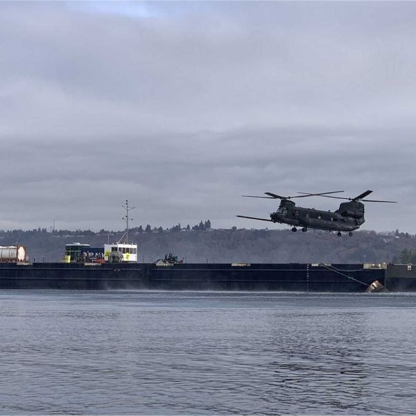 A U.S. Army MH-47G Chinook from the 160th Special Operations Aviation Regiment conducts replenishment operations from an autonomous barge equipped with Sea Machines Robotics’ SM300 system, demonstrating a new maritime logistics concept for long-range U.S. special operations missions.