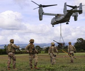 U.S. Army Soldiers from Bravo Battery, 3rd Battalion, 7th Field Artillery Regiment, 25th Infantry Division move clear after sling-loading an M119 105 mm howitzer beneath a U.S. Marine Corps MV-22B Osprey during training at Schofield Barracks, Hawaii, on August 19, 2026.
