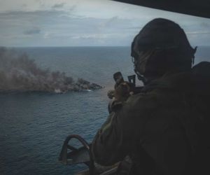 A U.S. Marine Corps UH-1Y Venom crew chief assigned to Marine Medium Tiltrotor Squadron (VMM) 365 (Reinforced), Littoral Combat Force-24, fires an M134 Minigun during a Maritime Interdiction Operation in the Pacific Ocean on September 15, 2026.