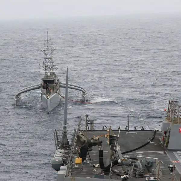 The U.S. Navy’s Seahawk unmanned surface vessel conducts an at-sea refueling with the Arleigh Burke-class guided-missile destroyer USS Chafee (DDG 90) on September 11, 2026, as the service develops procedures to sustain unmanned platforms during extended fleet operations. (Picture source: US DoD)