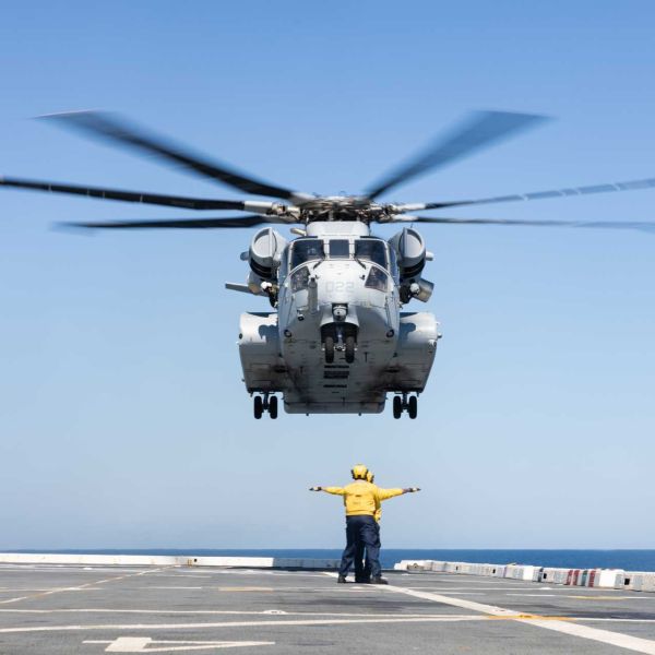 U.S. Marines assigned to Marine Heavy Helicopter Squadron HMH-461, operating under Marine Aircraft Group 29, 2nd Marine Aircraft Wing, work alongside U.S. Navy sailors as a CH-53K King Stallion conducts a deck landing aboard the San Antonio-class amphibious transport dock USS Arlington (LPD-24) during Exercise UNITAS 2025 off the coast of North Carolina on September 25, 2025.