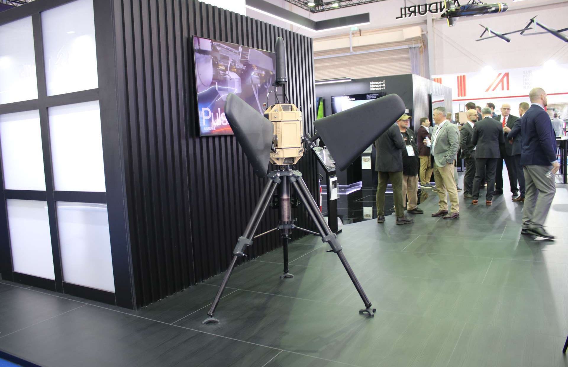 Anduril’s Pulsar is a tripod-mounted, 360-degree electronic warfare node that uses software-defined radio and edge computing to detect, identify, and direction-find hostile RF emissions, then apply focused jamming to disrupt small drones and other RF-controlled threats while minimizing interference with friendly communications (Picture source: Army Recognition Group).