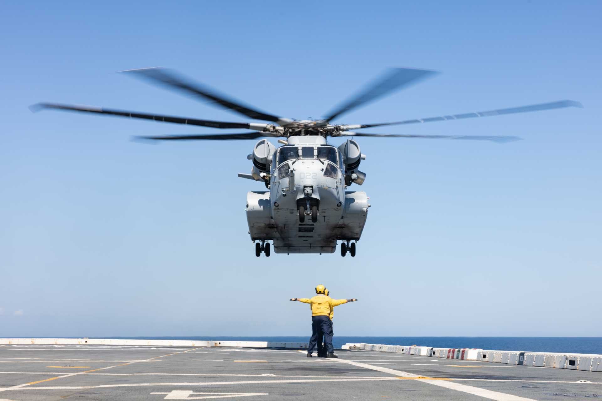 U.S. Marines assigned to Marine Heavy Helicopter Squadron HMH-461, operating under Marine Aircraft Group 29, 2nd Marine Aircraft Wing, work alongside U.S. Navy sailors as a CH-53K King Stallion conducts a deck landing aboard the San Antonio-class amphibious transport dock USS Arlington (LPD-24) during Exercise UNITAS 2025 off the coast of North Carolina on September 25, 2025.