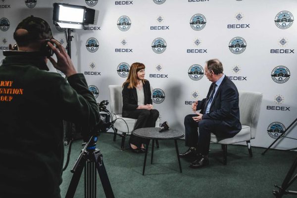 Pascale Delcomminette, CEO of the Wallonia Export & Investment Agency (AWEX), speaks with Alain Servaes, CEO of Army Recognition Group, during an interview at the Army Recognition Group Studio, Official Web TV of BEDEX 2026, discussing AWEX’s strategy to support Walloon companies entering the defense sector and integrating into international military supply chains.