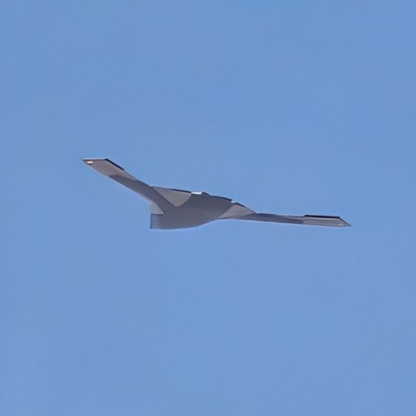 The imagery shows split outboard control surfaces, a common solution on flying wings to manage yaw and roll, as well as a dorsal hump above the rear section, suggesting an embedded exhaust and therefore a twin-engine configuration