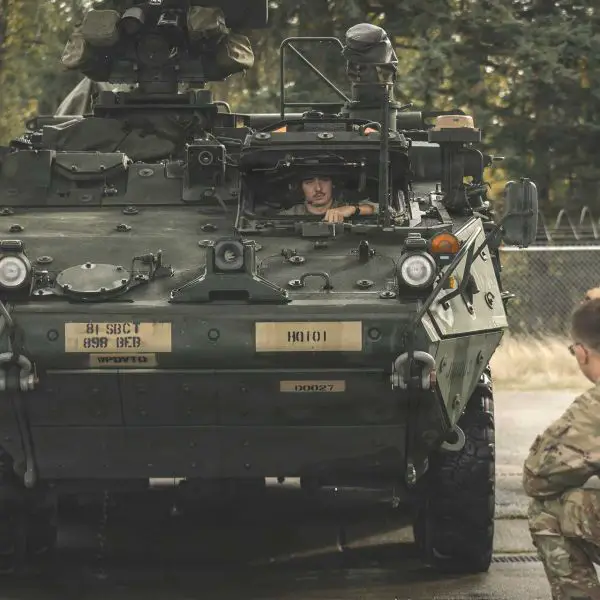 U.S. Soldiers from the 898th Brigade Engineer Battalion, part of the 81st Stryker Brigade Combat Team, Washington National Guard, direct a Stryker armored vehicle to the wash rack for turn-in at the Unit Training and Equipment Site on Joint Base Lewis-McChord, Washington, Oct. 17, 2025.