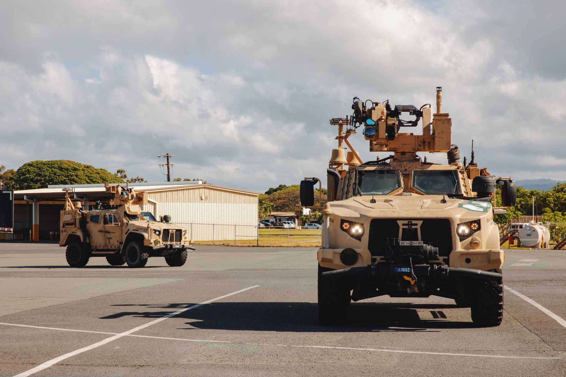 U.S. Marine Air Defense Integrated System vehicles assigned to the 3rd Littoral Anti-Air Battalion, 3rd Marine Littoral Regiment, 3rd Marine Division, conduct convoy operations during a loading exercise onto a U.S. Air Force C-17A Globemaster III operated by the 535th Airlift Squadron at Joint Base Pearl Harbor-Hickam, Hawaii, May 9, 2025.
