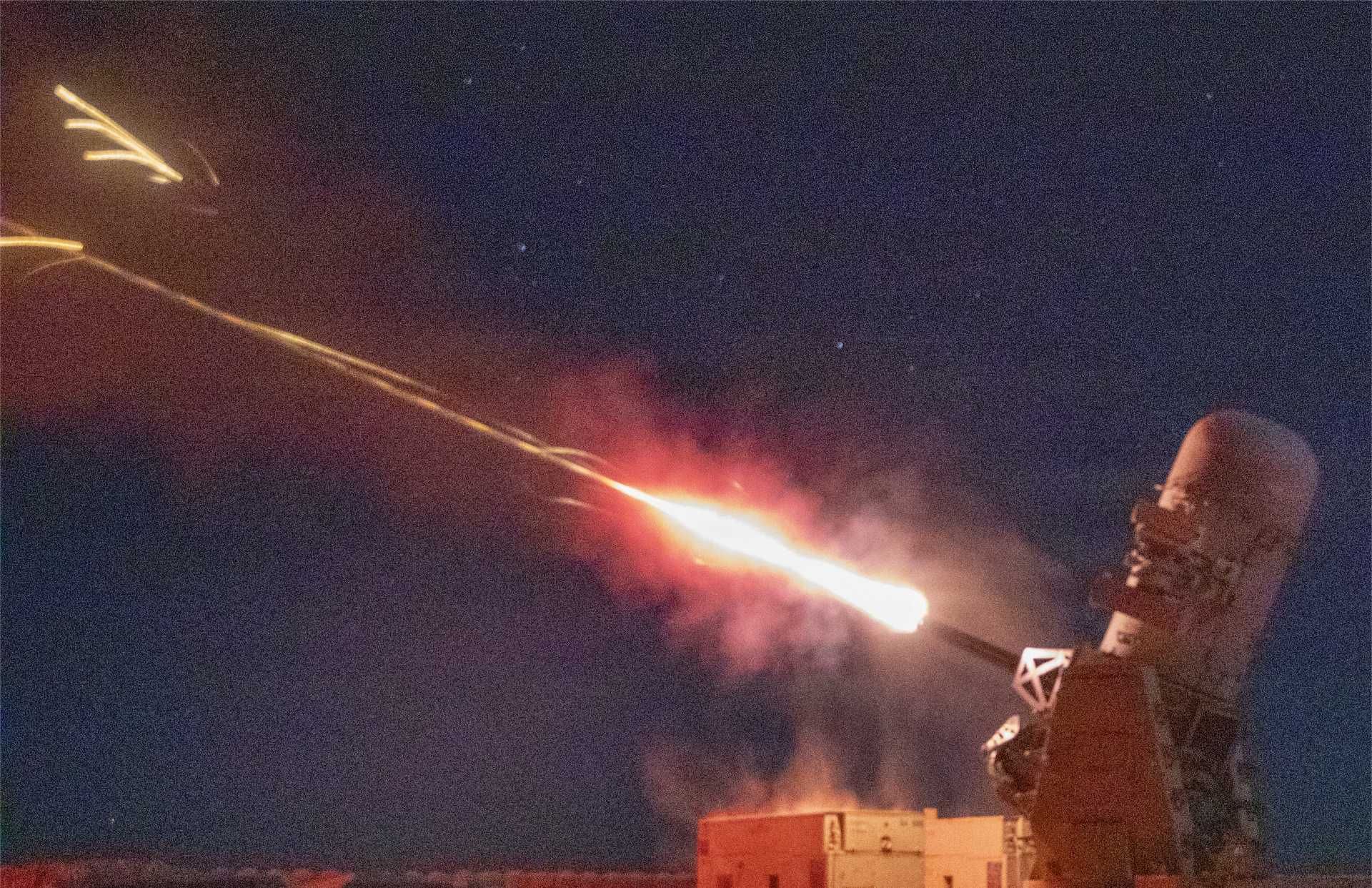 U.S. C-RAM system fires to counter aerial threats during a test in the CENTCOM area, highlighting its role in defending critical installations against drones and rockets.