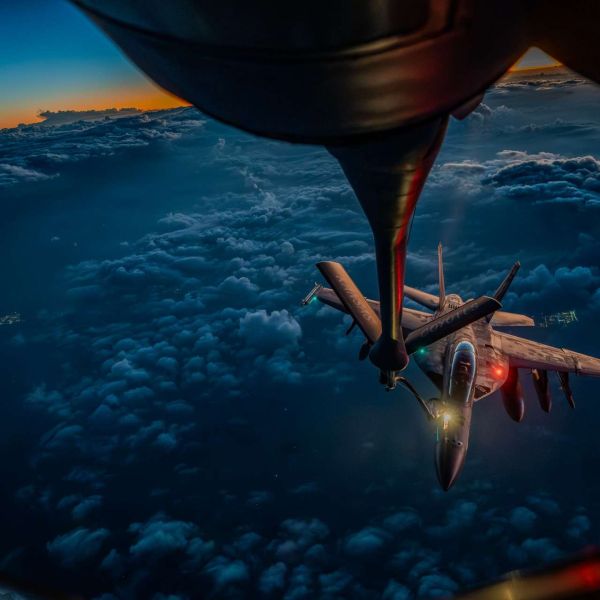 A U.S. Air Force KC-135 Stratotanker refuels a U.S. Navy F/A-18F Super Hornet over the Middle East during Operation Epic Fury, illustrating the joint aerial refueling support that extends fighter endurance, sustains strike tempo, and increases time on station for combat missions (Picture source: U.S. DoW).
