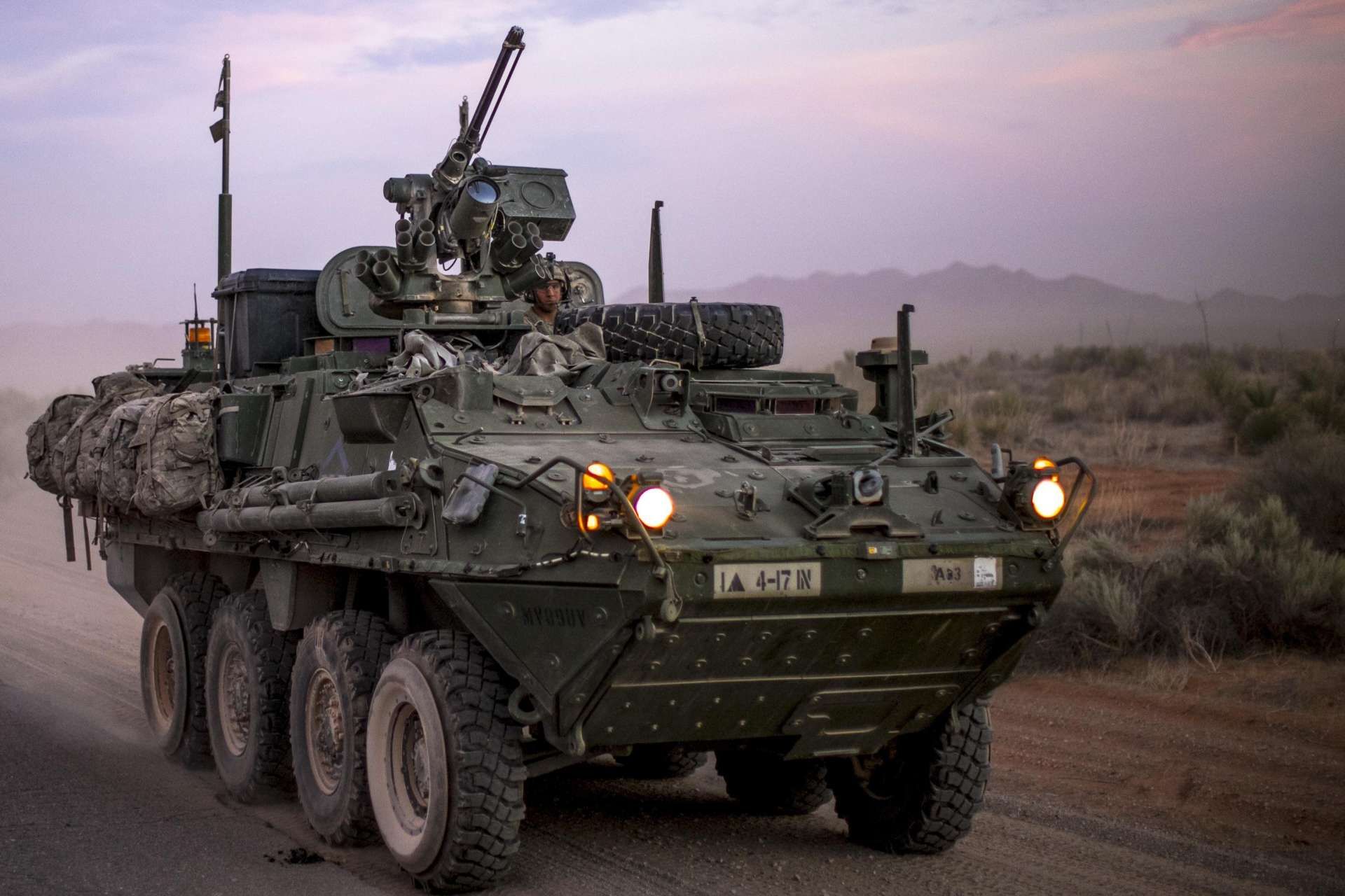 A U.S. Army Stryker from the 1st Brigade Combat Team, 4th Battalion, 17th Infantry Regiment maneuvers past a Combat Aviation Brigade convoy during movement to the division-level Iron Focus field exercise, illustrating coordinated ground and aviation operations (Picture Source: DVIDS)