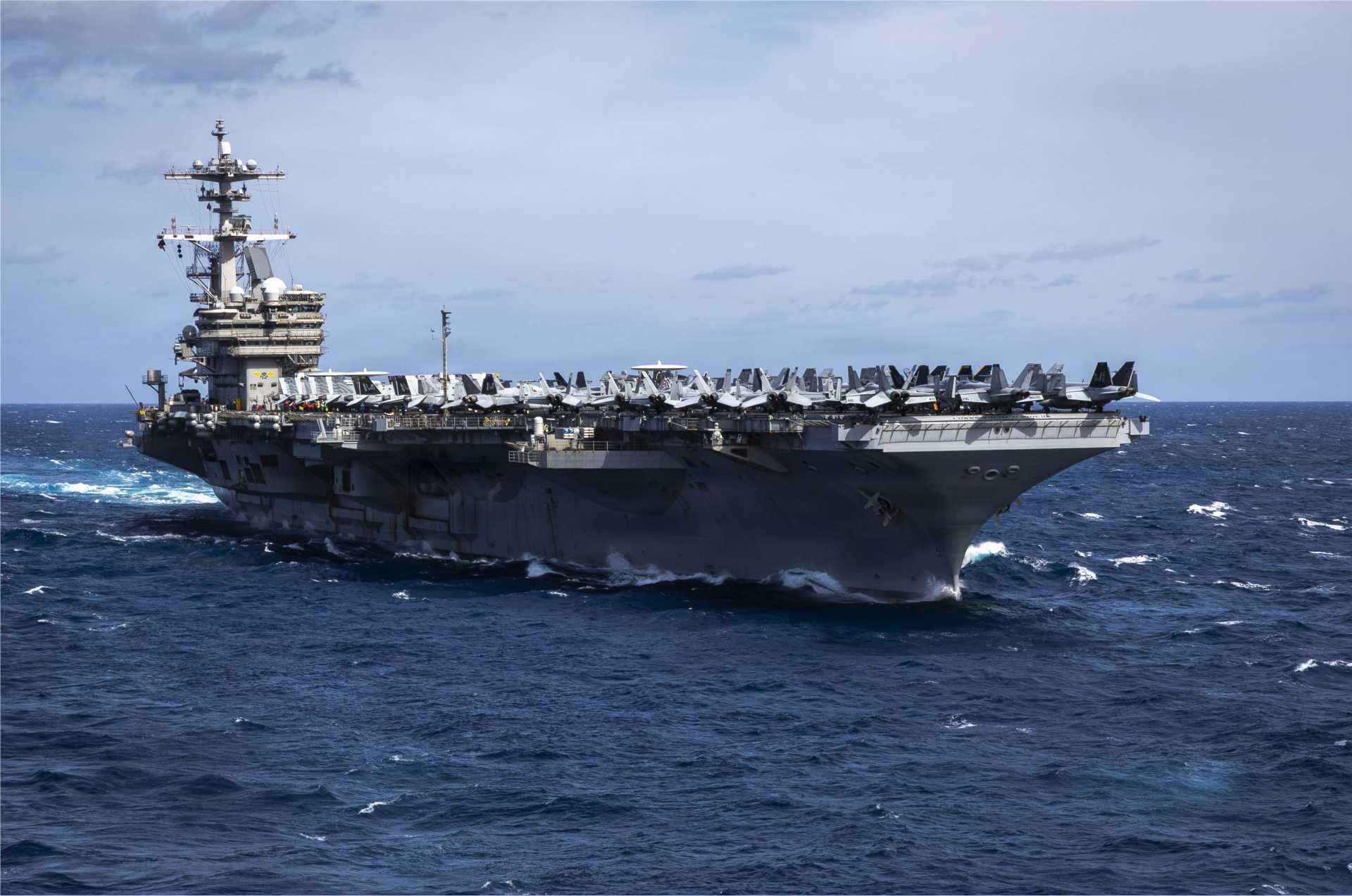 USS George H.W. Bush (CVN-77), a Nimitz-class nuclear-powered aircraft carrier of the U.S. Navy, sails during operations at sea. The carrier is preparing for potential deployment to the Middle East as part of a Carrier Strike Group reinforcing U.S. naval presence near Iran.
