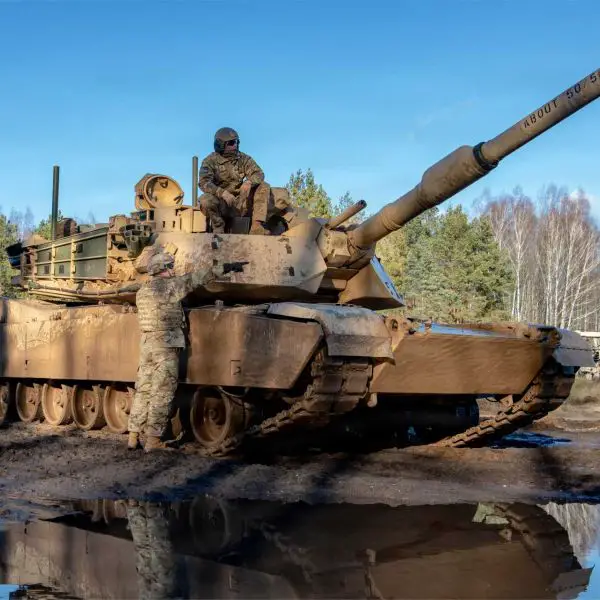 U.S. Army Soldiers from 3rd Battalion, 66th Armored Regiment, 1st Armored Brigade Combat Team, 1st Infantry Division gather ground-level intelligence from scout teams after completing a convoy movement of M1A2 Abrams tanks from their designated start point during the Forward Land Forces expansion exercise at Bemowo Piskie, Poland.