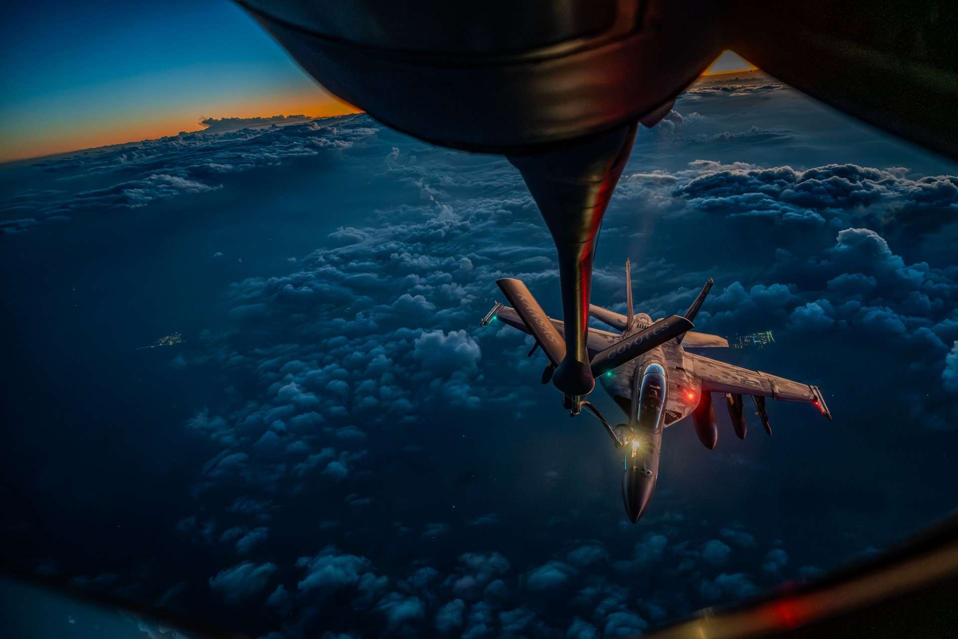 A U.S. Air Force KC-135 Stratotanker refuels a U.S. Navy F/A-18F Super Hornet over the Middle East during Operation Epic Fury, illustrating the joint aerial refueling support that extends fighter endurance, sustains strike tempo, and increases time on station for combat missions (Picture source: U.S. DoW).