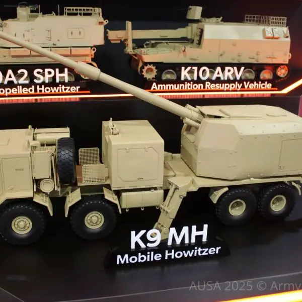 Hanwha Aerospace’s K9A2 MH wheeled 155 mm howitzer mock-up on display at AUSA 2025 in Washington, featuring an automatic turret with a 52-caliber gun; US Army trials are planned for early 2026.