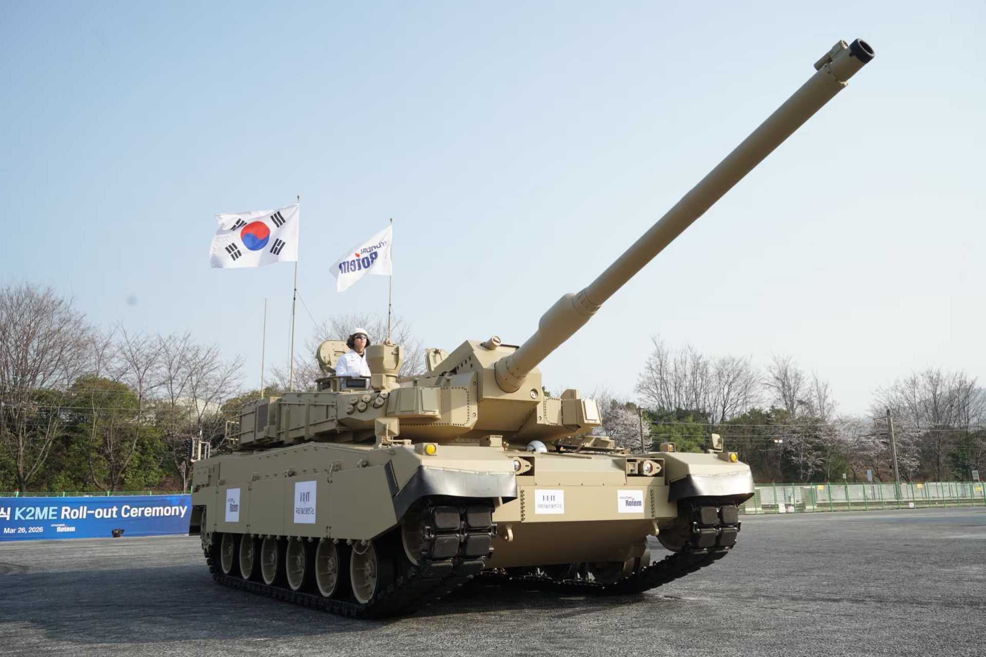 Hyundai Rotem’s K2ME main battle tank during its official rollout ceremony at Changwon, showcasing enhanced cooling systems and desert-optimized configuration for sustained operations in extreme Middle Eastern environments.