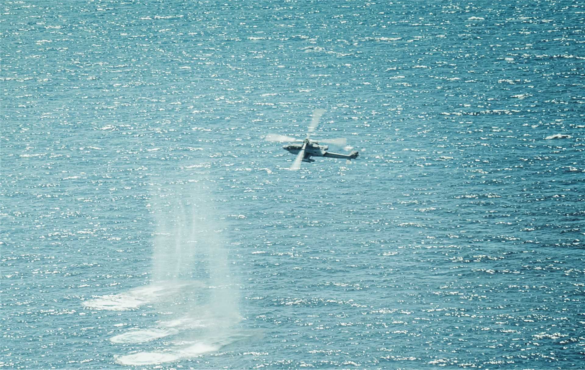 A U.S. Marine Corps AH-1Z Viper attack helicopter assigned to Marine Medium Tiltrotor Squadron 263 (Reinforced), 22nd Marine Expeditionary Unit (Special Operations Capable), conducts precision strikes on maritime targets during a live fire exercise in the Caribbean Sea, September 22, 2025.