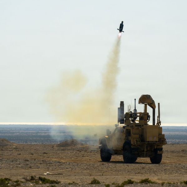A MRAP vehicle fitted with a Mobile Low Slow Small Unmanned Aircraft Integrated Defeat System launcher fires a counter-drone interceptor at a fixed-wing target during a training exercise in Bahrain.