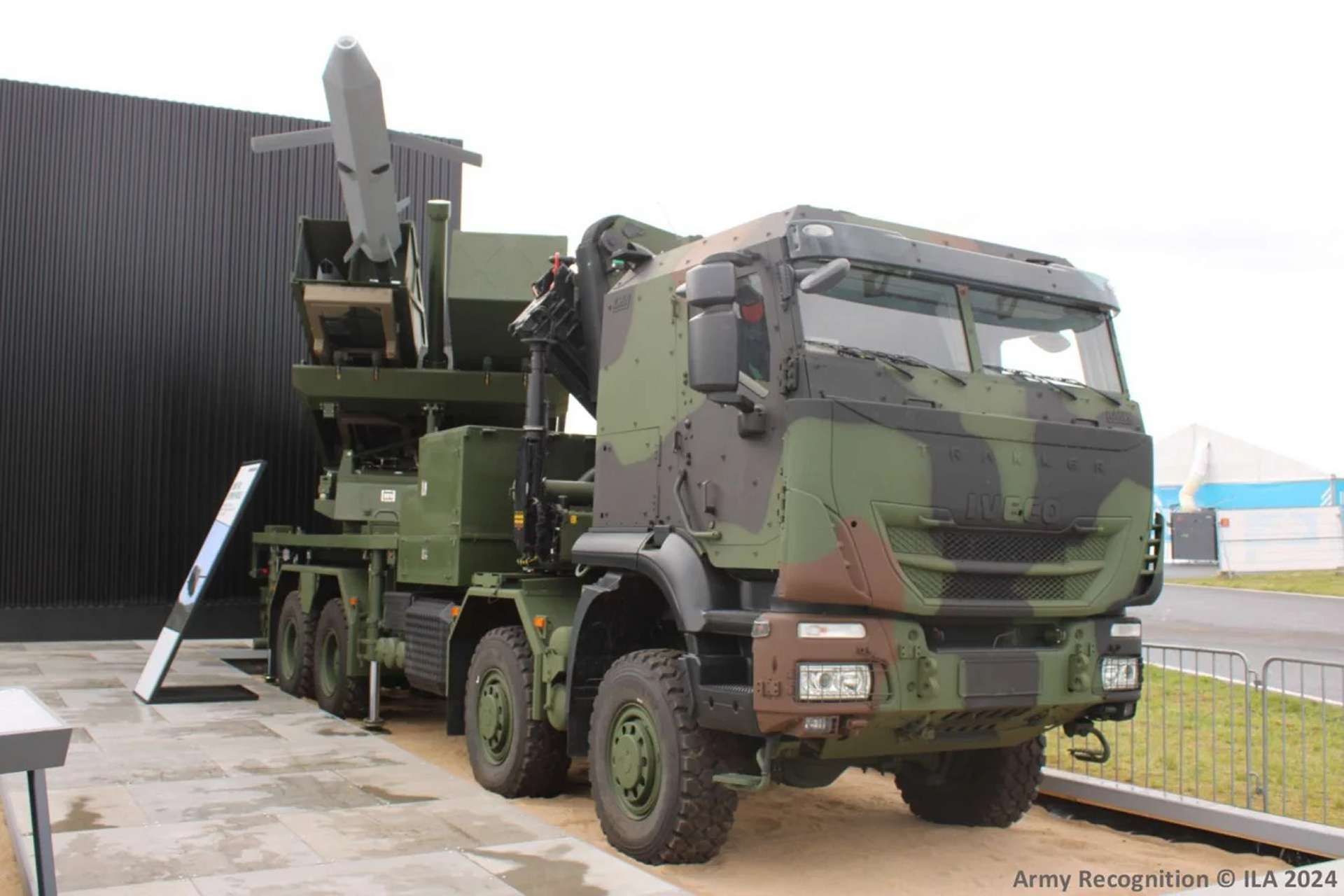 MARS 3 (EuroPULS) is a wheeled, rapid “shoot-and-scoot” rocket artillery launcher with a two-pod modular payload that can fire precision-guided rockets and missiles from short range to roughly 300 km, delivering massed salvos, deep interdiction, and time-sensitive strikes against air defenses, command posts, and logistics while remaining highly mobile and hard to target (Picture source: Army Recognition Group).