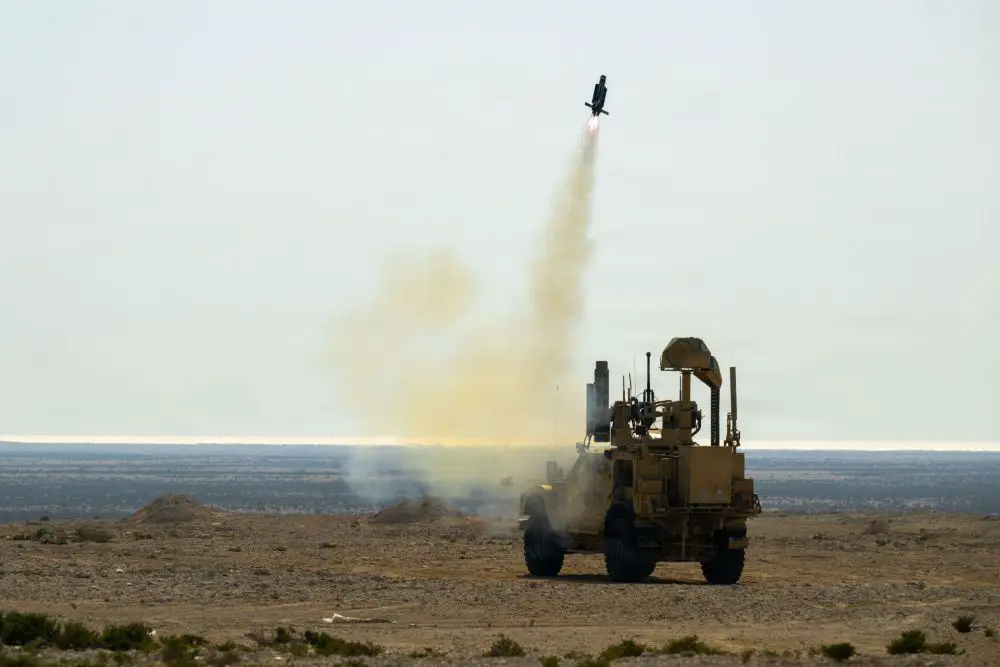 A MRAP vehicle fitted with a Mobile Low Slow Small Unmanned Aircraft Integrated Defeat System launcher fires a counter-drone interceptor at a fixed-wing target during a training exercise in Bahrain.