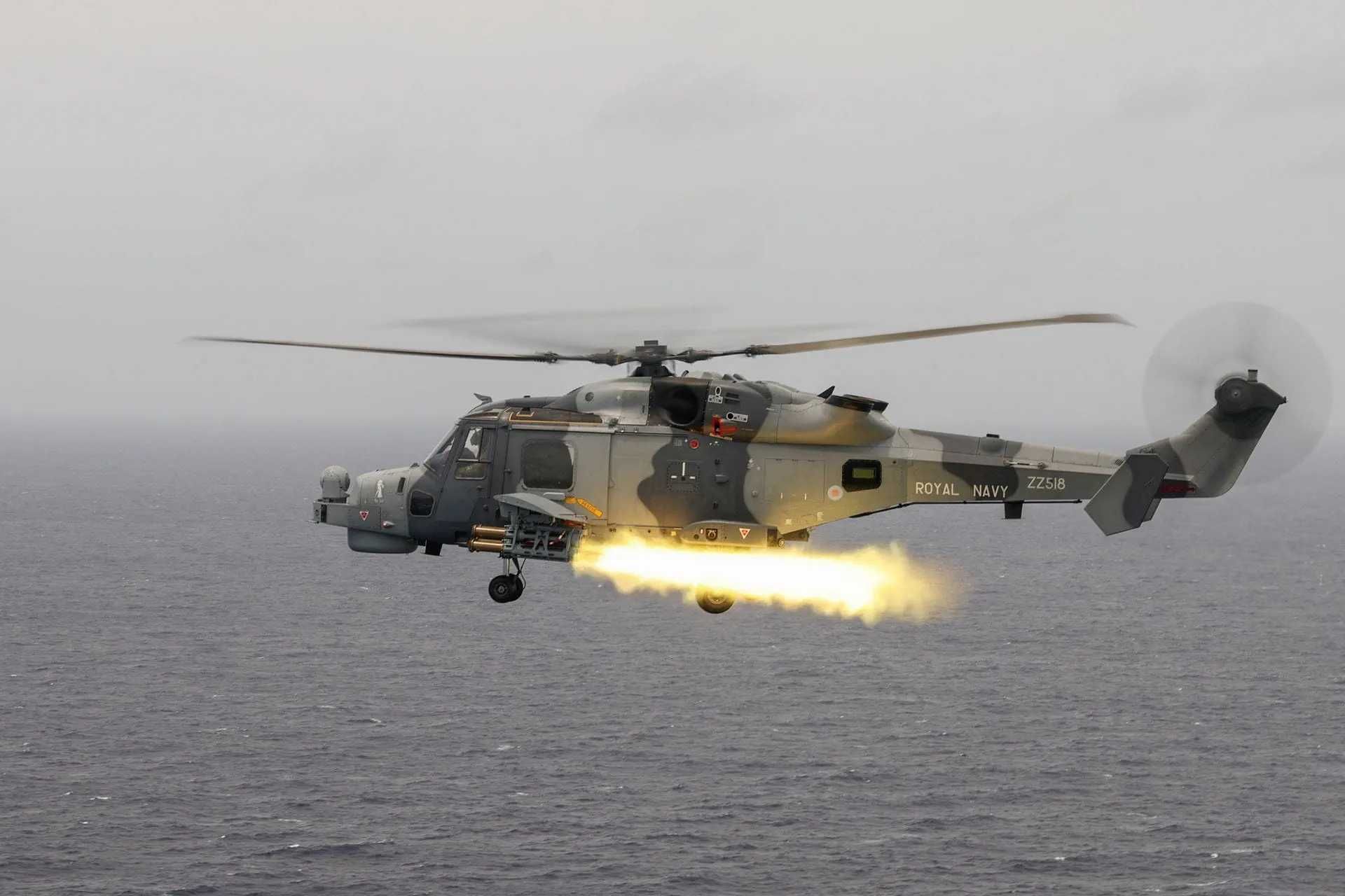British Royal Navy Wildcat HMA2 helicopter of 815 Naval Air Squadron launches a Martlet anti-ship missile during live-fire trials, showcasing its precision engagement capability against fast-moving maritime threats.