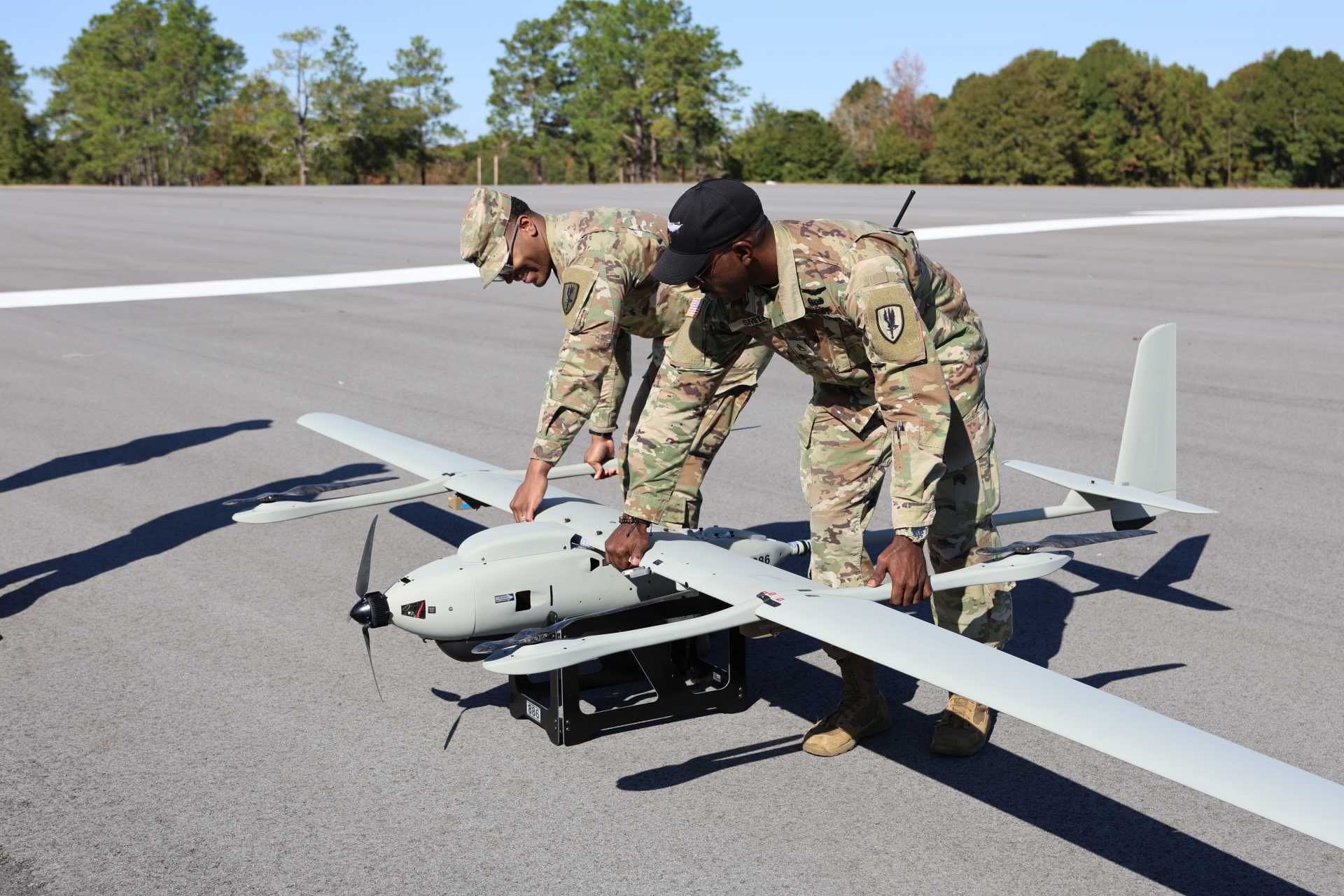 U.S. Army Aviation soldiers Sgt. Joshua Capers and Staff Sgt. Alwyne Smith of the 1st Aviation Brigade adjust the position of a VXE30 Stalker uncrewed aircraft during a training session at Fort Rucker on November 18, 2025.