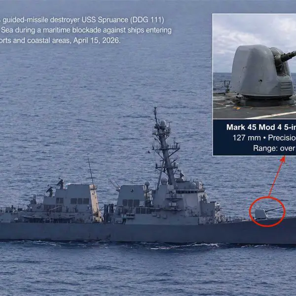 U.S. Navy USS Spruance (DDG-111) conducts maritime interdiction operations in the Arabian Sea on April 15, 2026, with inset highlighting the Mark 45 Mod 4 127 mm naval gun used to deliver precision disabling fire during the seizure of the Iranian-flagged container ship Touska.