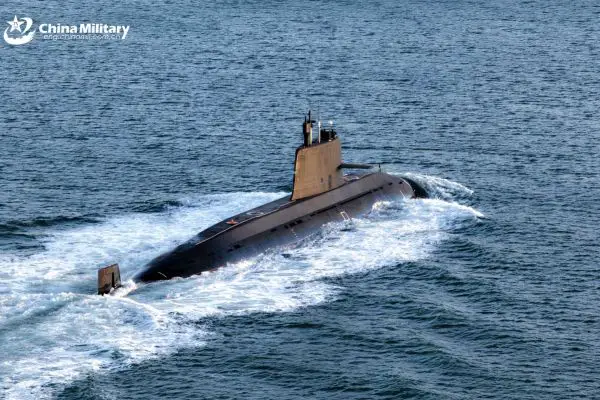 A Chinese People’s Liberation Army Navy nuclear-powered submarine sails during naval operations as China advances nuclear clock technology that could allow future submarines to navigate with extreme precision without GPS, potentially challenging U.S. Navy anti-submarine warfare dominance in the Indo-Pacific region.