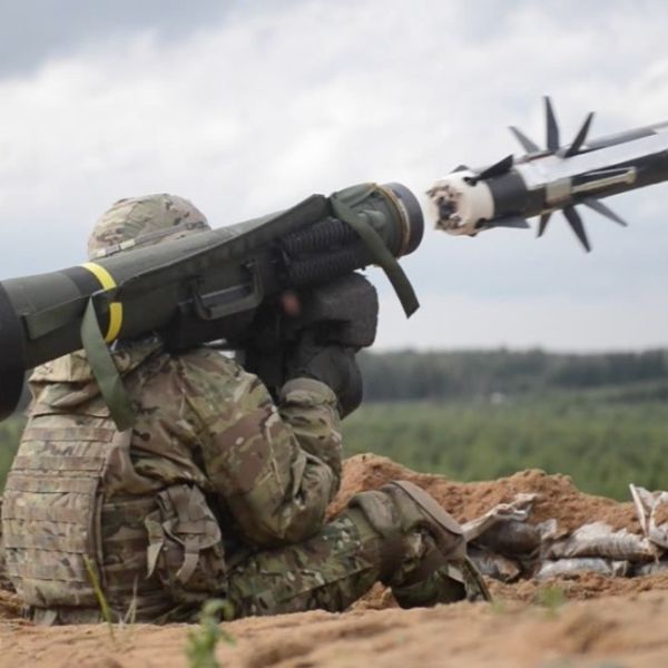 A soldier fires an FGM-148 Javelin, launching the anti-tank missile toward a distant armored target (Picture Source: U.S. Army)