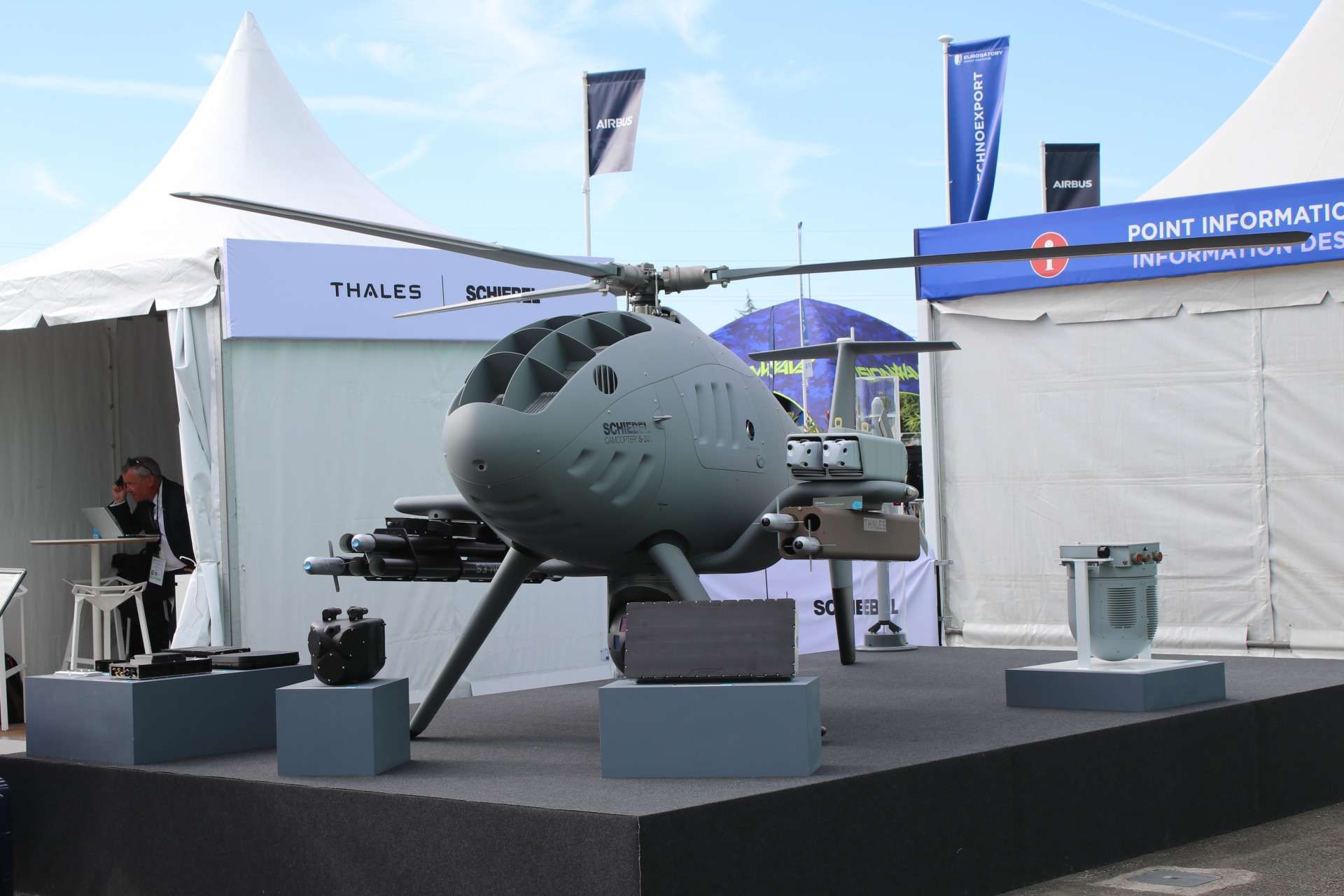 Schiebel and Thales unveiled an armed CAMCOPTER S-301 VTOL unmanned aircraft at Eurosatory 2026, integrating loitering munitions, guided rockets, and advanced sensors into a single multi-role combat system (Picture Source: Army Recognition Group)