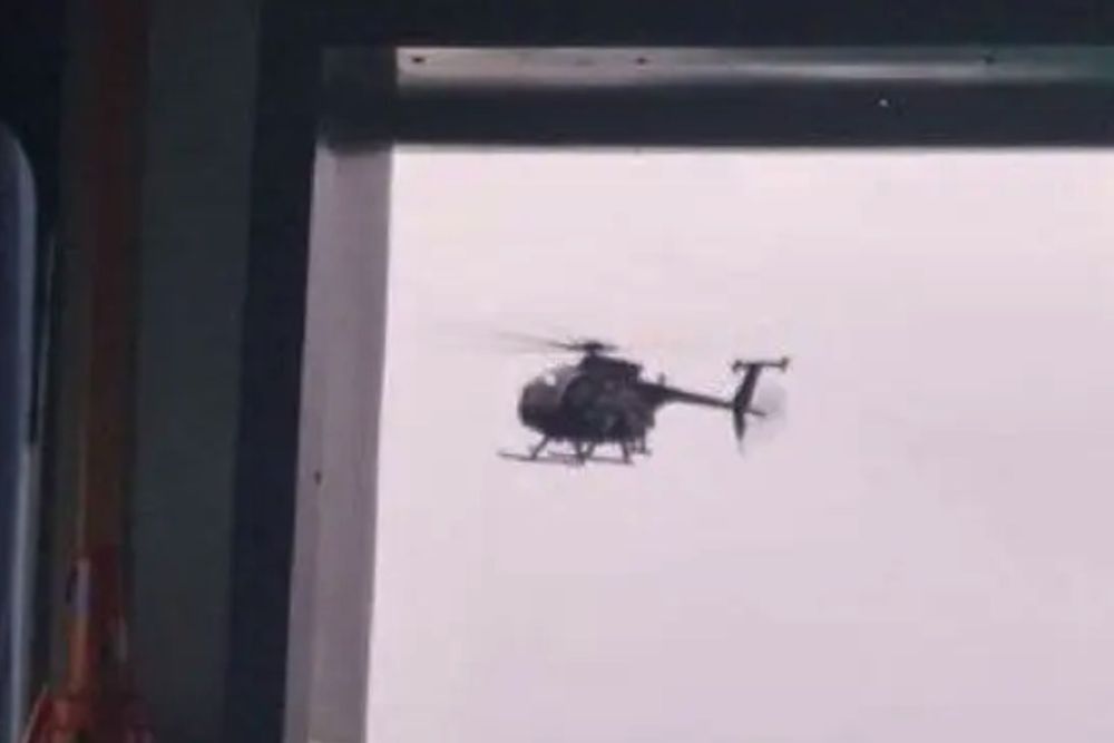 Screenshot from a video filmed by crew members aboard the tanker shows a helicopter approaching the vessel during the U.S. interception operation. (Picture source: X channel @WarMonitor3 )