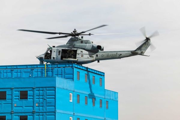 A UH-1Y Venom helicopter from the U.S. Marine Corps, operated by Marine Operational Test and Evaluation Squadron 1, practices simulated rooftop insertion maneuvers at Deuce Village within the Berry M. Goldwater Range Complex near Yuma, Arizona, on January 21, 2026.