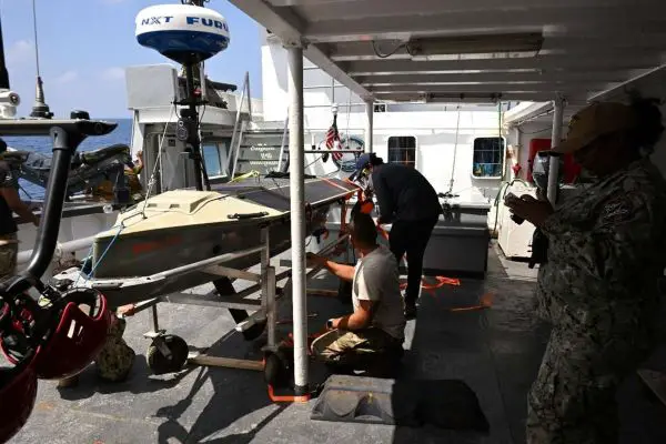 Lightfish is a solar-powered unmanned surface vessel that can be launched and recovered from small ships, operate for months with limited connectivity, and carry modular sensors to extend maritime surveillance, track vessels via AIS, and support coalition patrols across vast sea areas (Picture source: U.S. Navy).